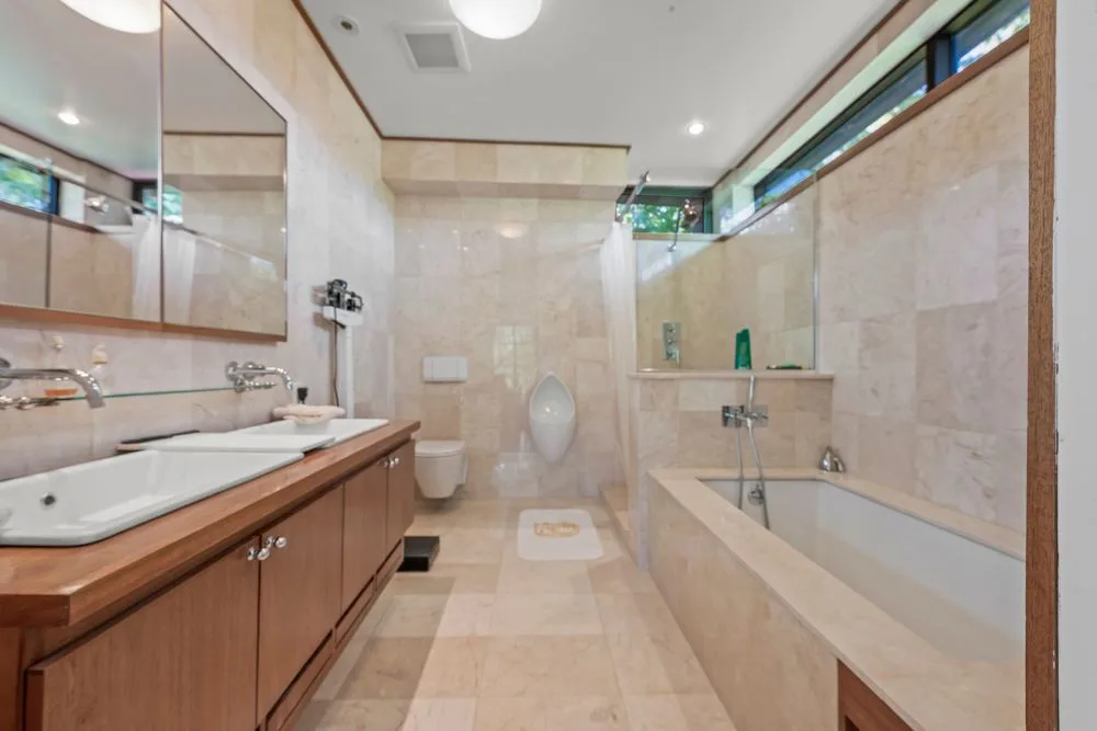 Warm stone bathroom at Modern architectural home